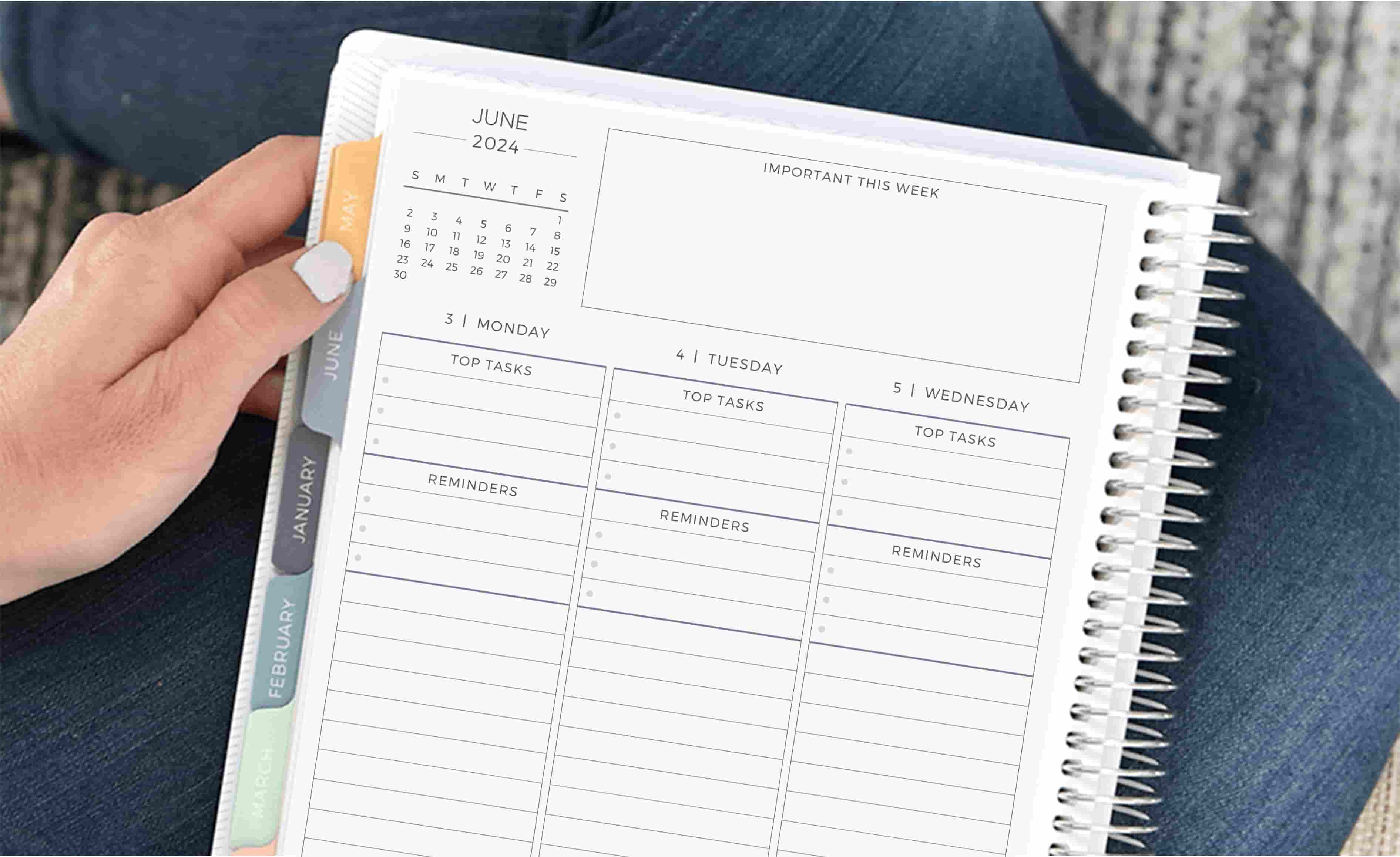 Planner with customizable layout being held on lap