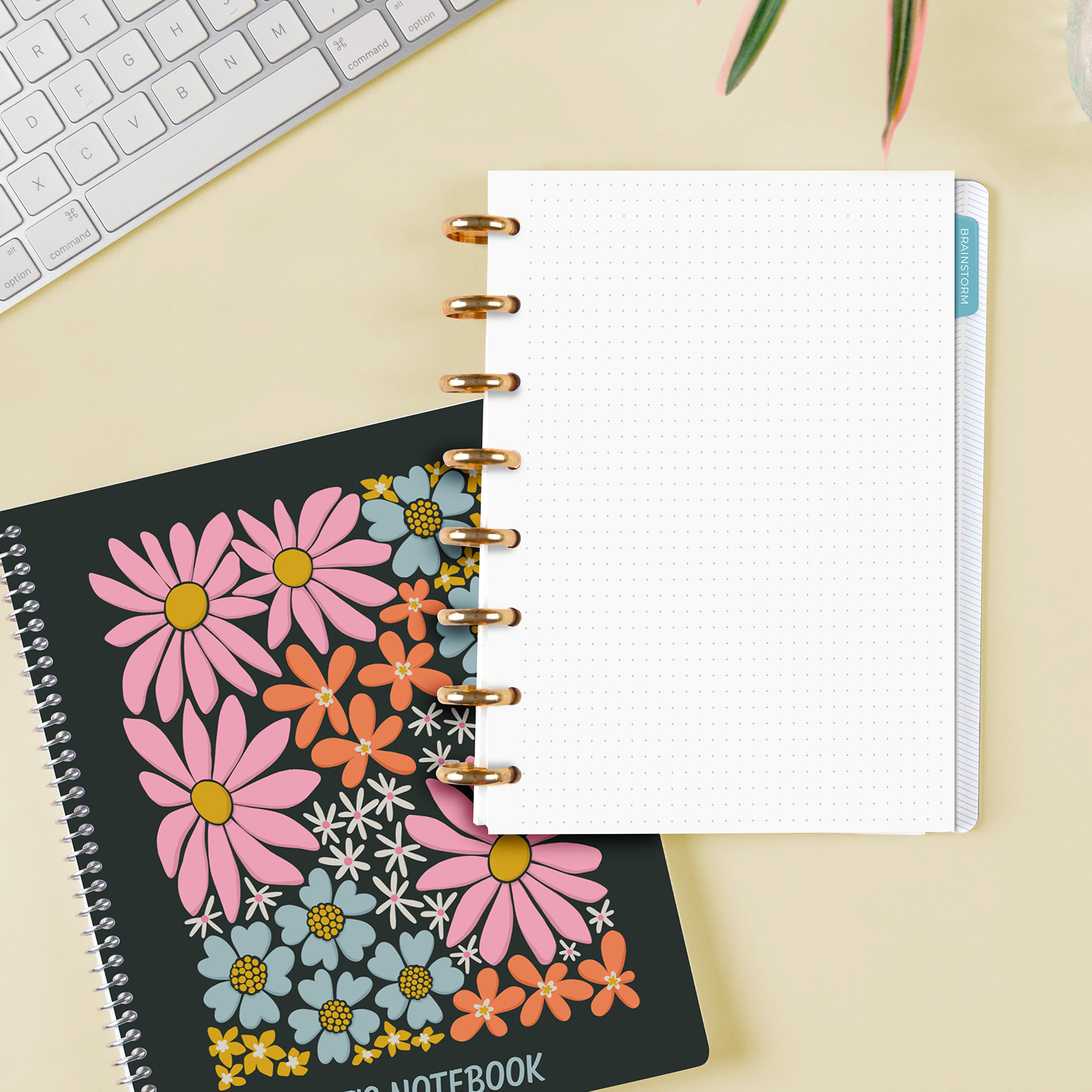 Discbound Notebook on desk with floral notebook cover underneath Discbound Notebook on desk with floral notebook cover underneath