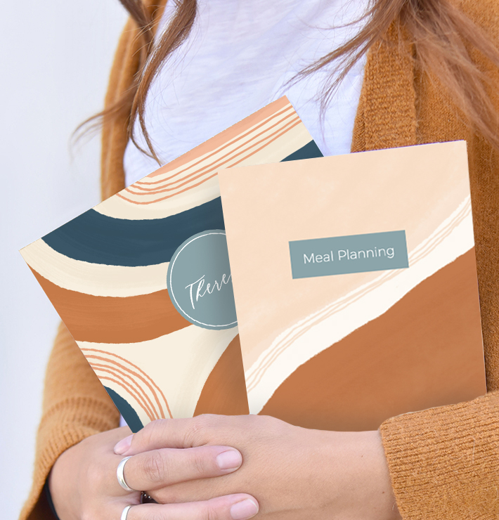 a woman holding two personalized journals