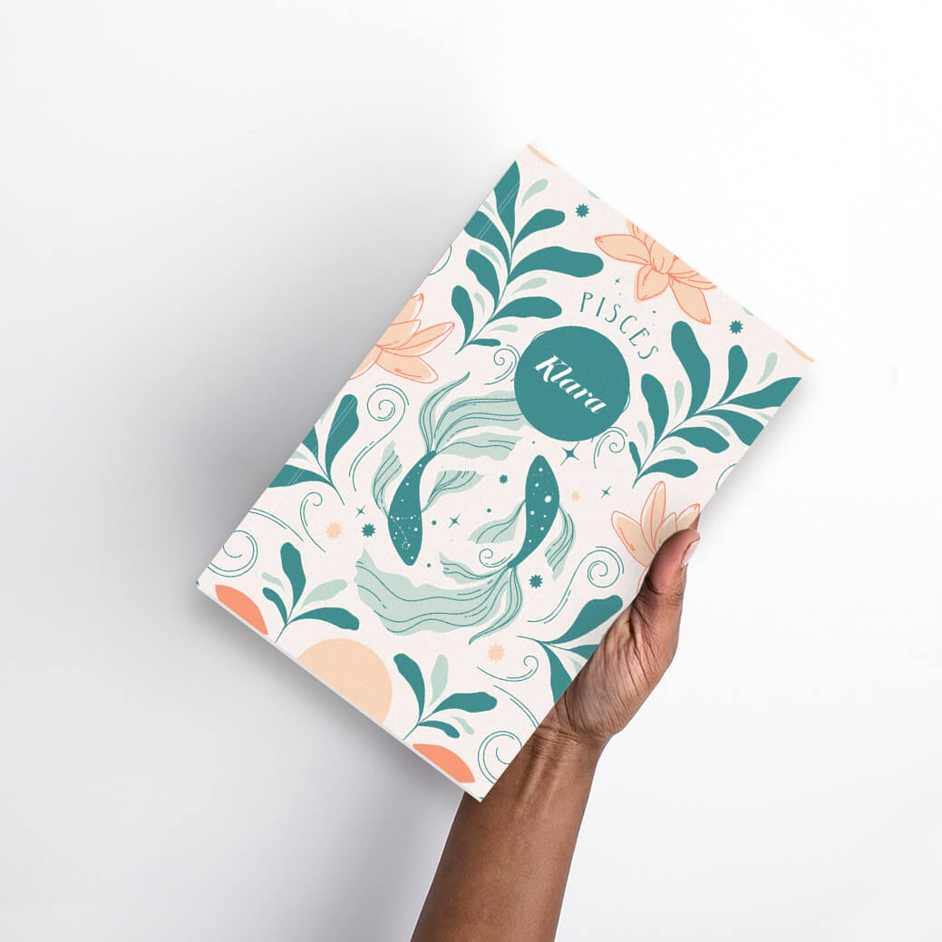 Woman holding small saddle stitched planner with personalized cover Woman holding small saddle stitched planner with personalized cover