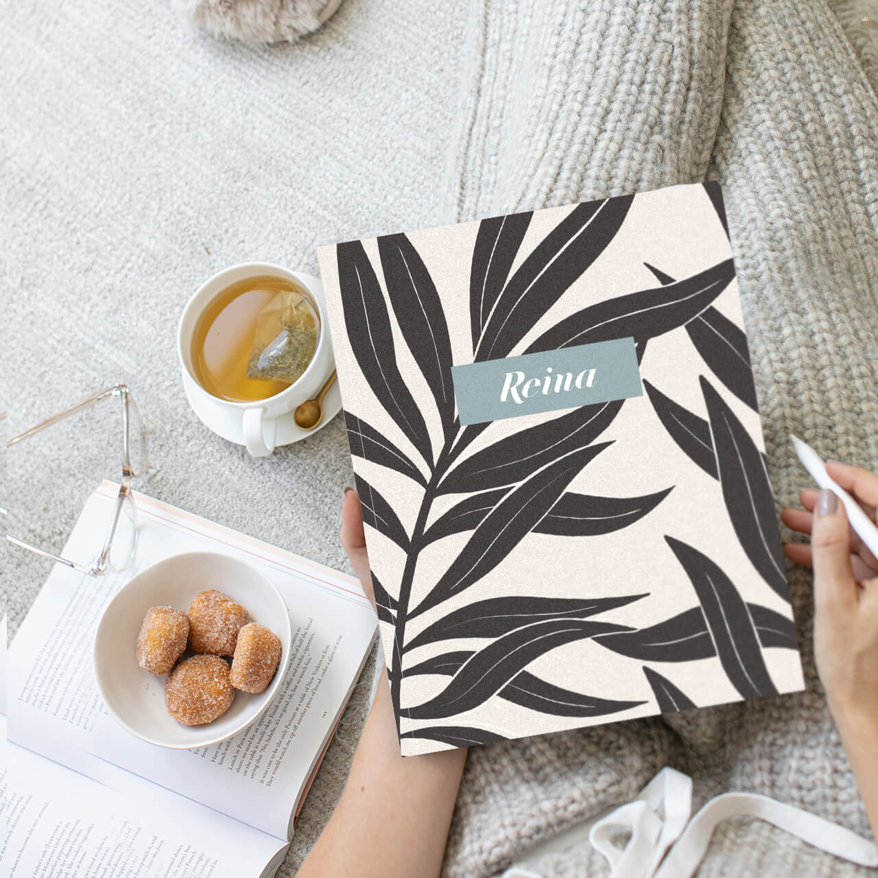 Woman holding a medium saddle stitched planner with a personalized cover Woman holding a medium saddle stitched planner with a personalized cover