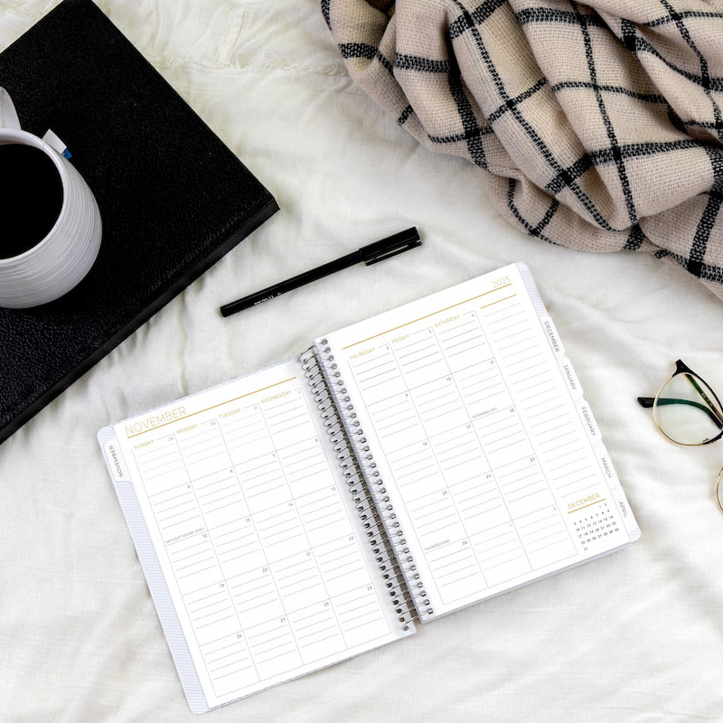 2 people with modern planners open, lifestyle living room scene