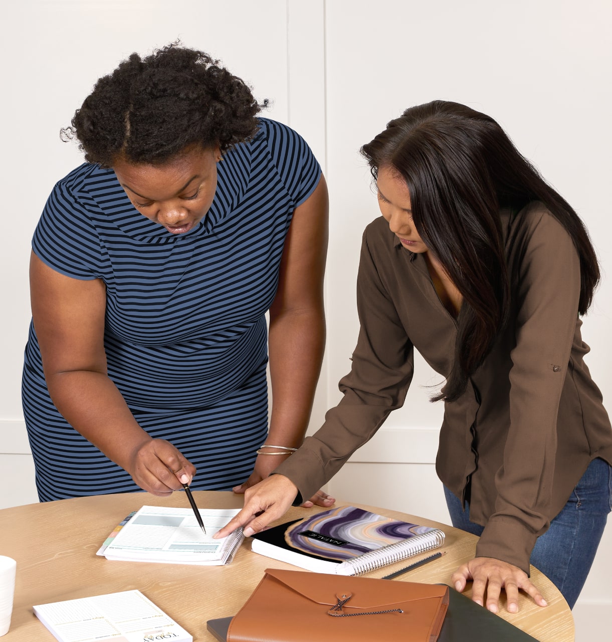 Two women looking at a daily planner