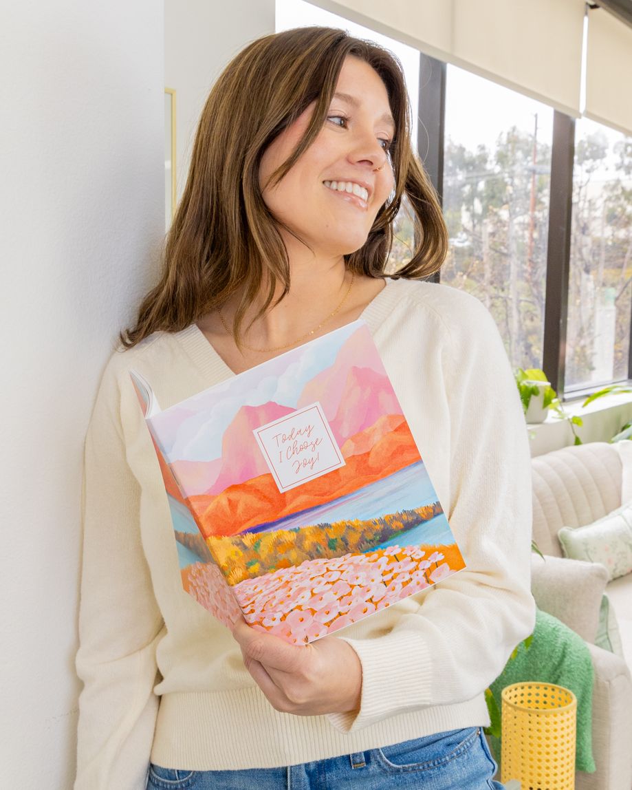 Person holding a planner smiling Person holding a planner smiling