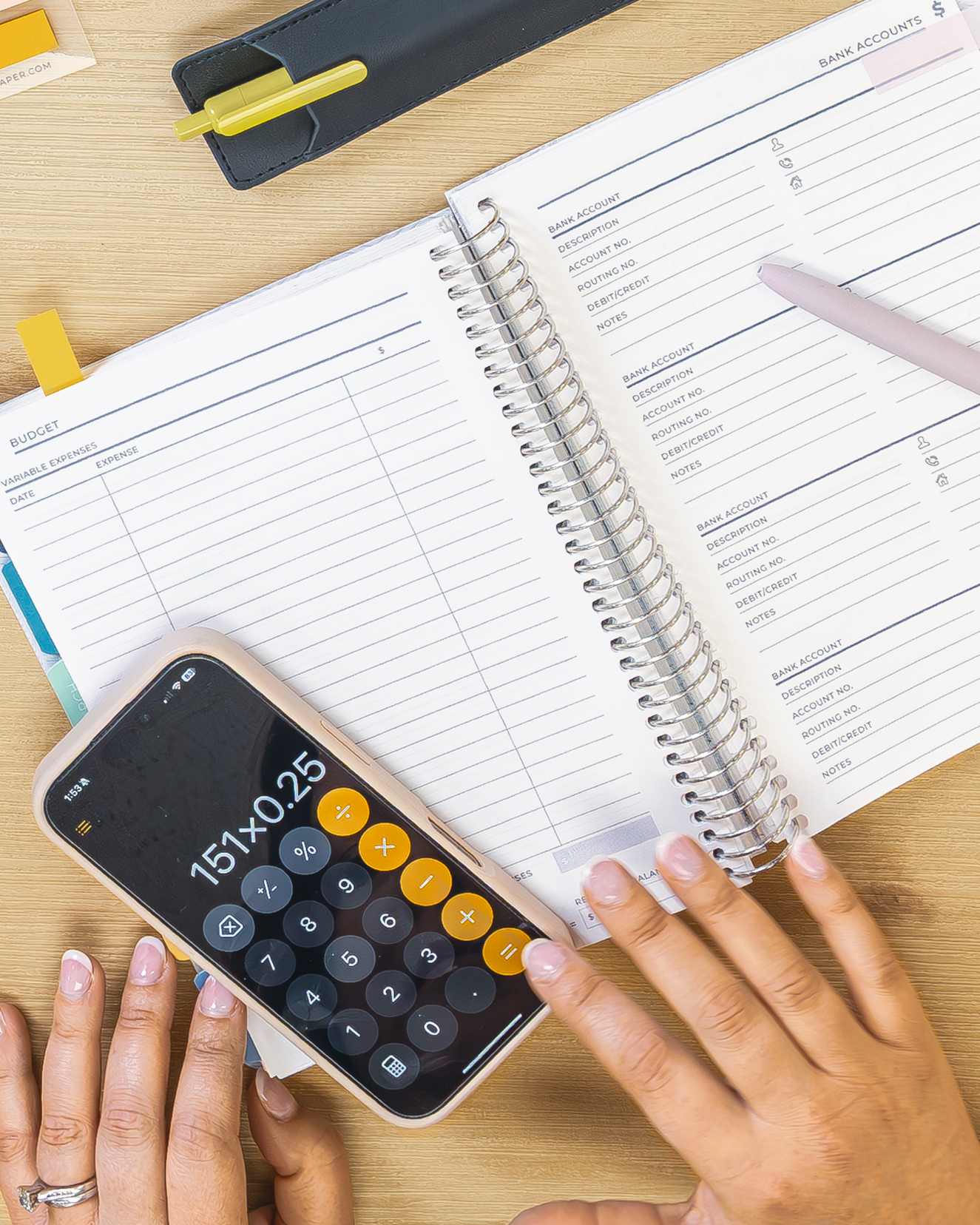 Financial Planner on a table showing a person working on a calculator Financial Planner on a table showing a person working on a calculator