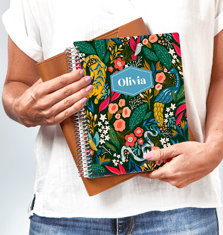 Woman holding a planner with a customized cover