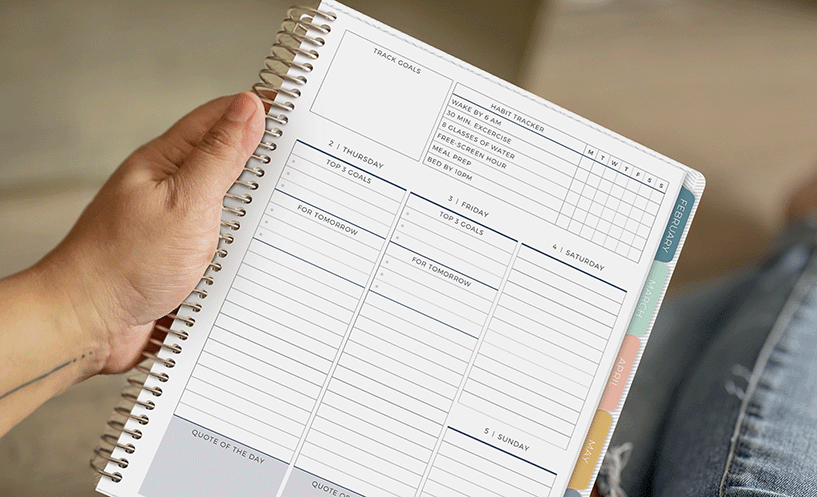 Hand holding Vertical Priorities Planner with custom headers Hand holding Vertical Priorities Planner with custom headers