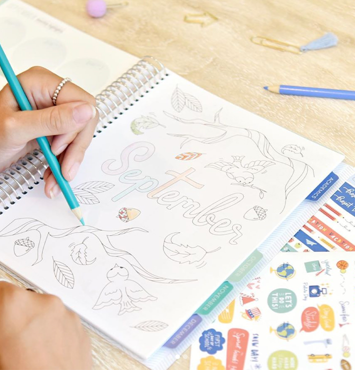 Person coloring September's monthly coloring page in Elementary Planner