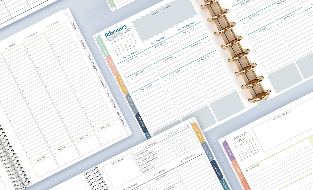 Multiple open planners with different layouts laying flat