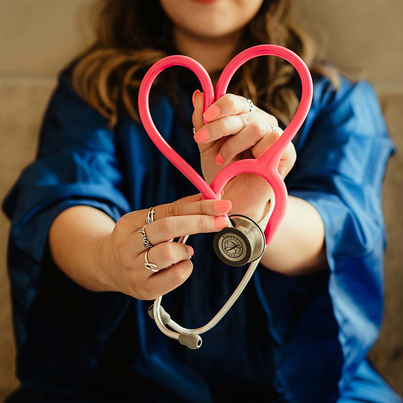 nurse holding a stethoscope as a heart