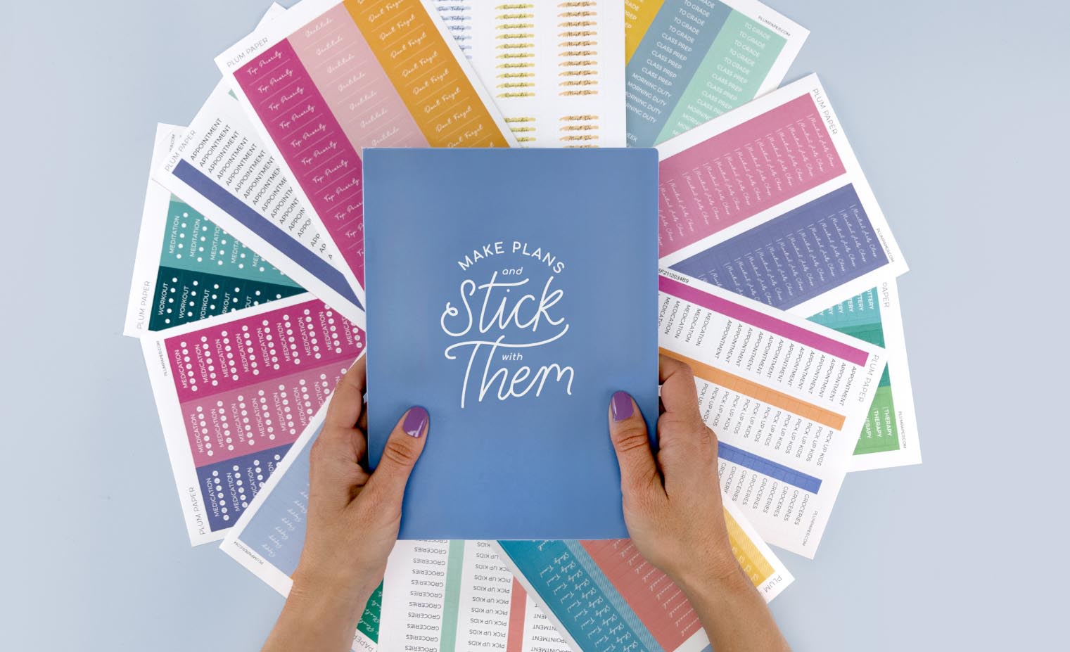 woman holding sticker book over custom stickers