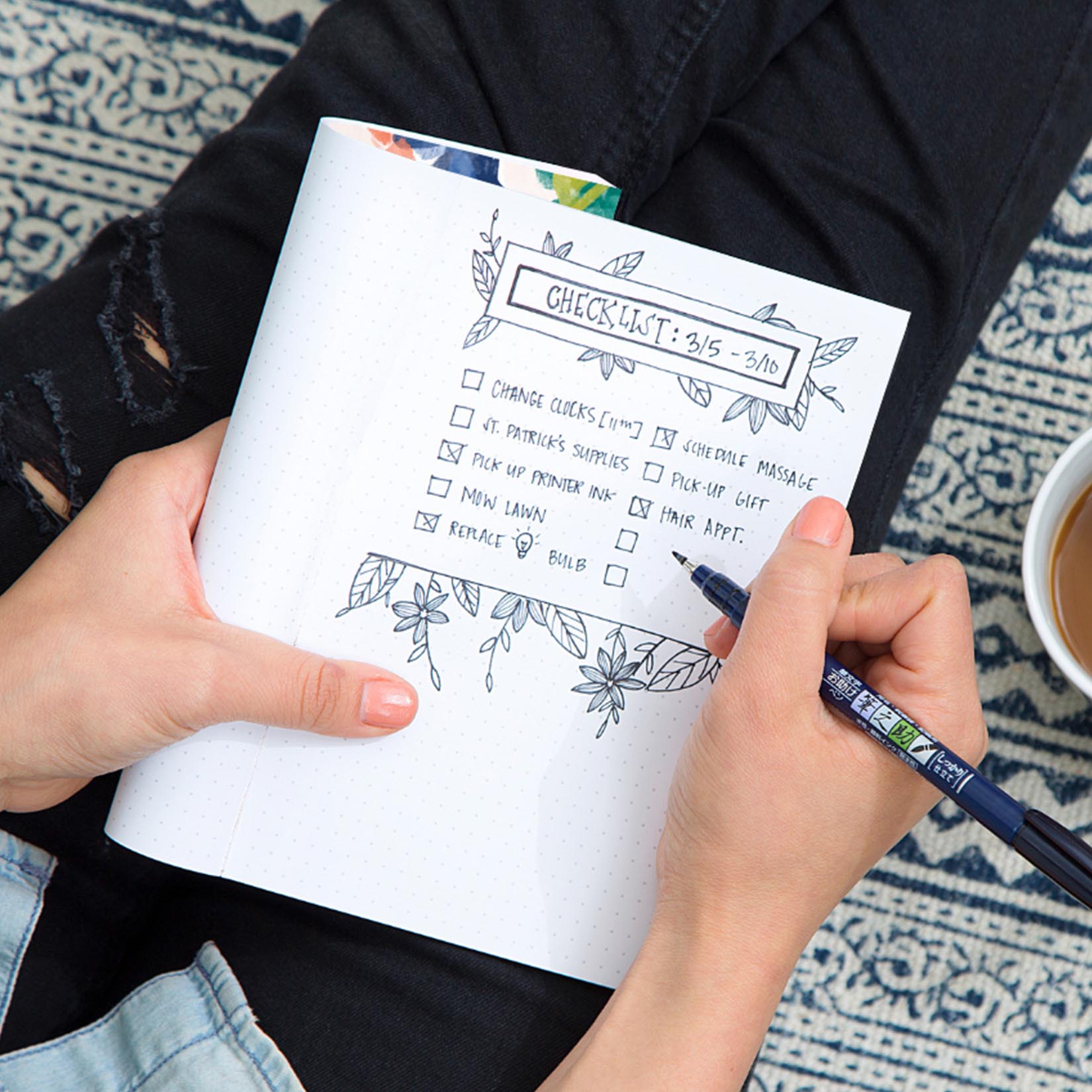 Woman writing in Bullet Journal made checklist Woman writing in Bullet Journal made checklist