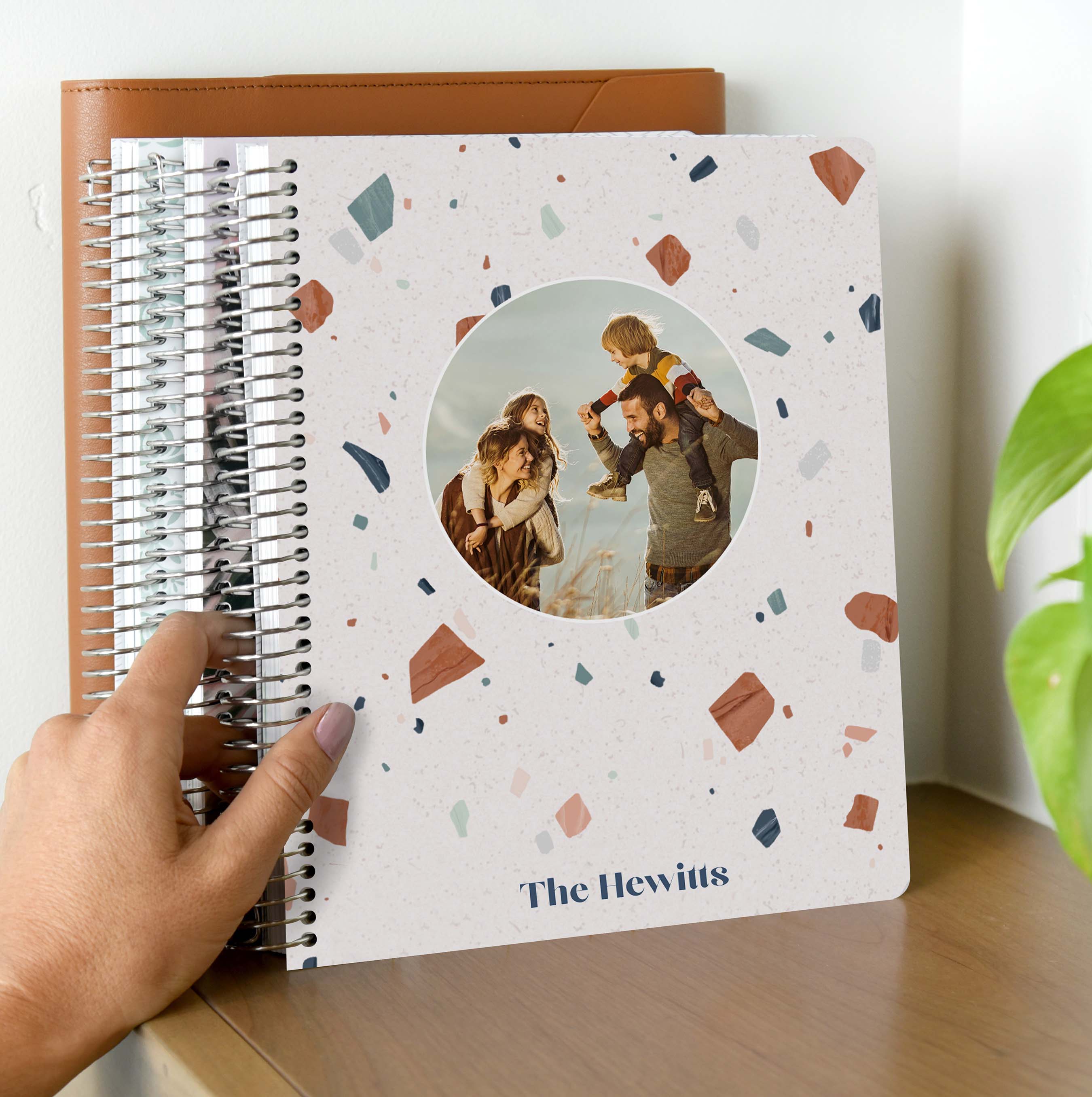 Person putting customized planner on shelf. Person putting customized planner on shelf.