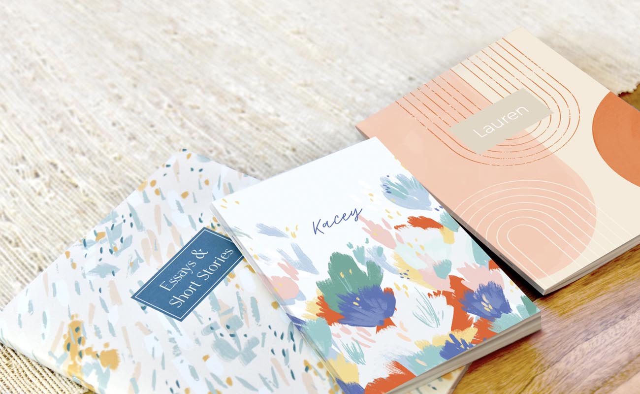 A small, medium, and large personalized journals on the floor
