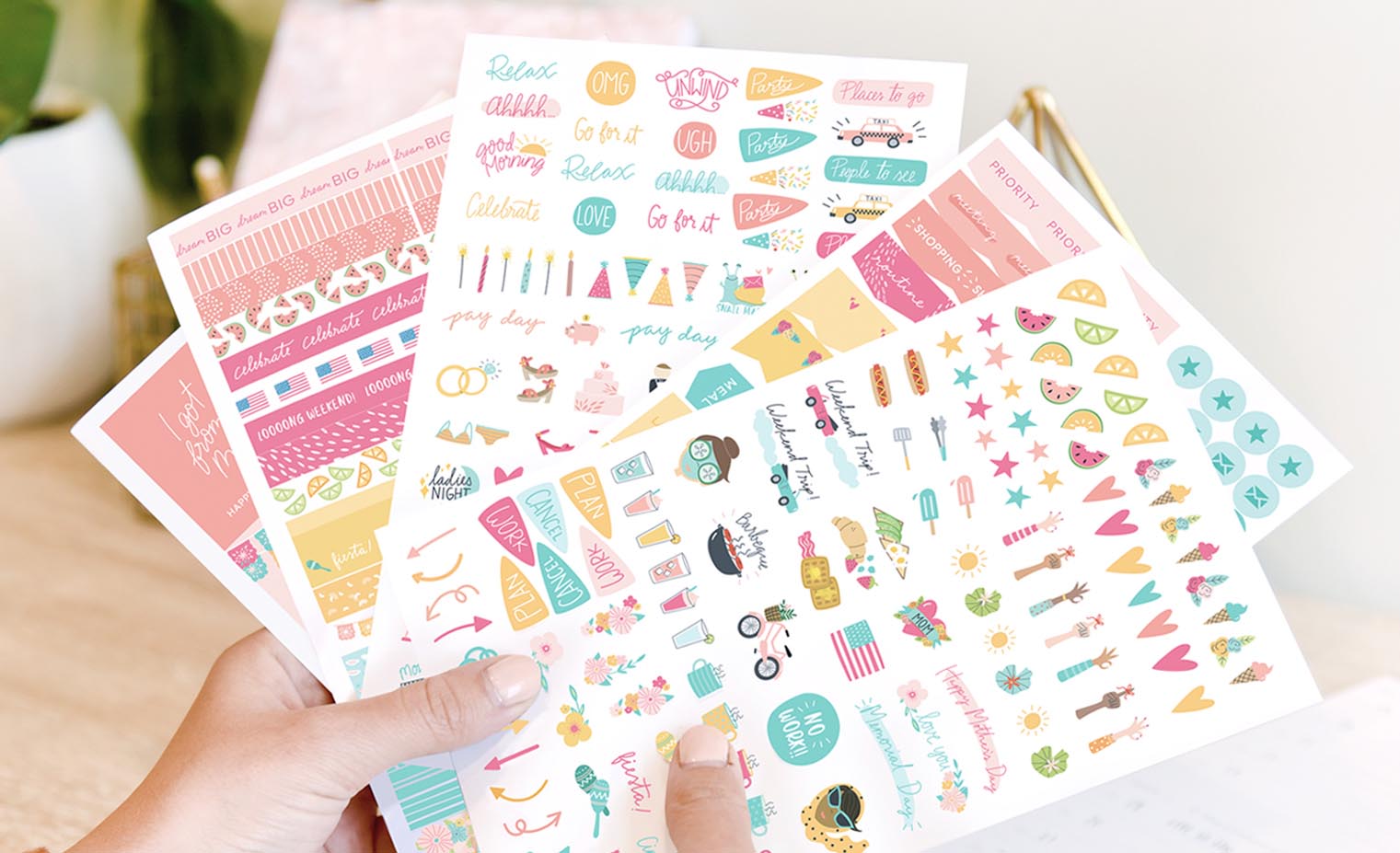 Woman holding 5 sheets of stickers