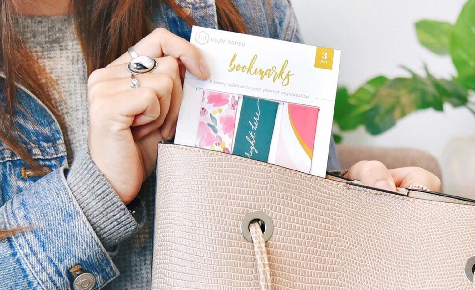 woman pulling magnetic bookmarks out of a bag