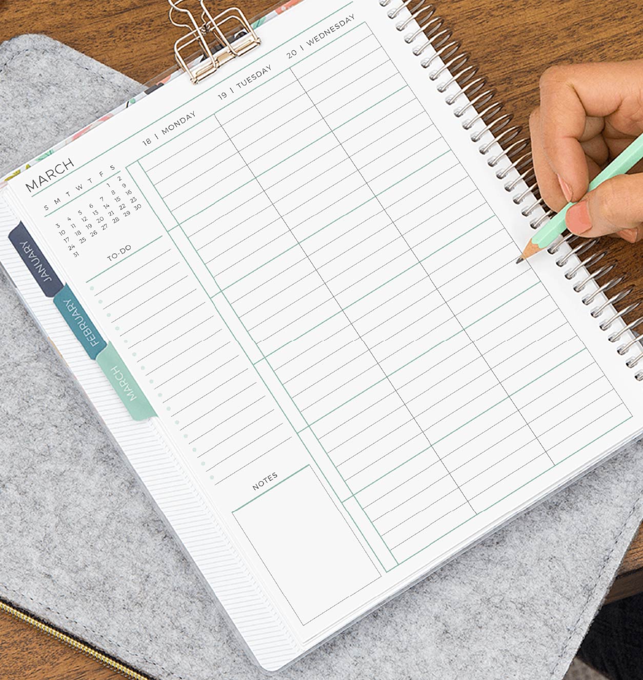 Someone writing in an ME Weekly Planner 