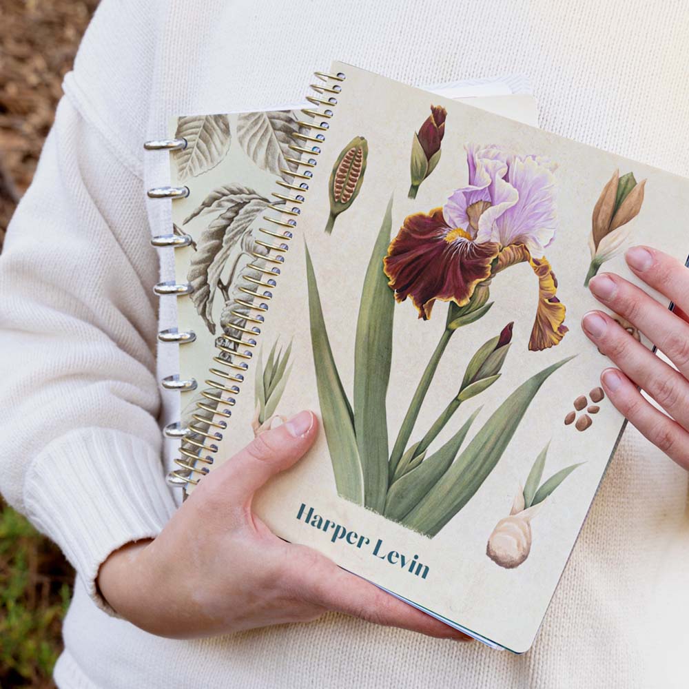 Woman holding two planners with different binding