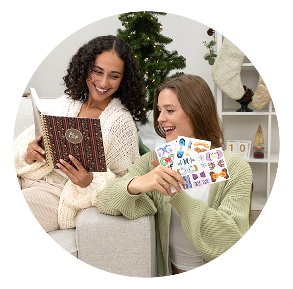 Two women smiling together on a cozy couch, using Plum Paper handmade planners and colorful sticker sheets — capturing joyful holiday planning moments with personalized 2026 custom planners and stationery gifts. Two women smiling together on a cozy couch, using Plum Paper handmade planners and colorful sticker sheets — capturing joyful holiday planning moments with personalized 2026 custom planners and stationery gifts.