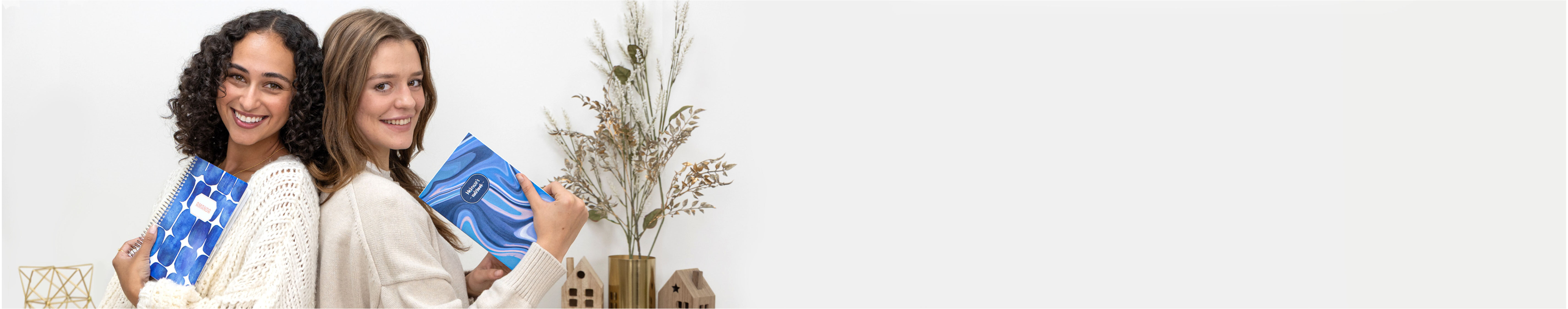 two women with blue winter planners two women with blue winter planners