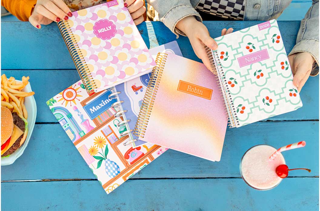 multiple Plum Paper planners on a table multiple Plum Paper planners on a table