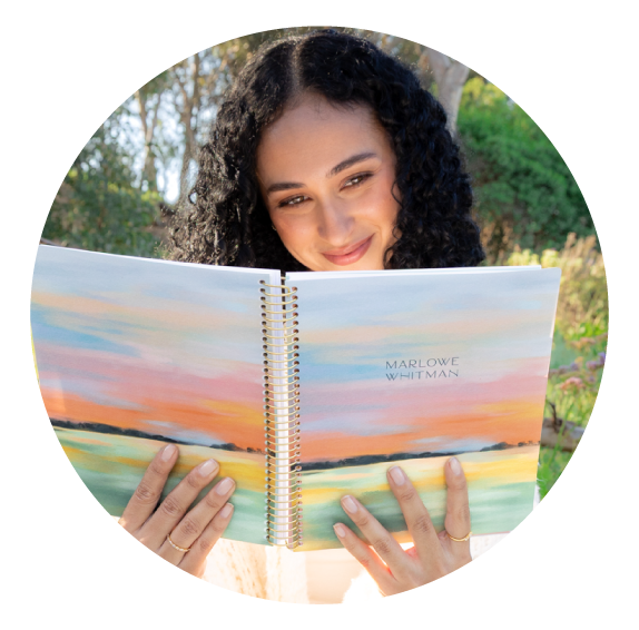 Woman reviewing her planner while planning goals and daily tasks Woman reviewing her planner while planning goals and daily tasks