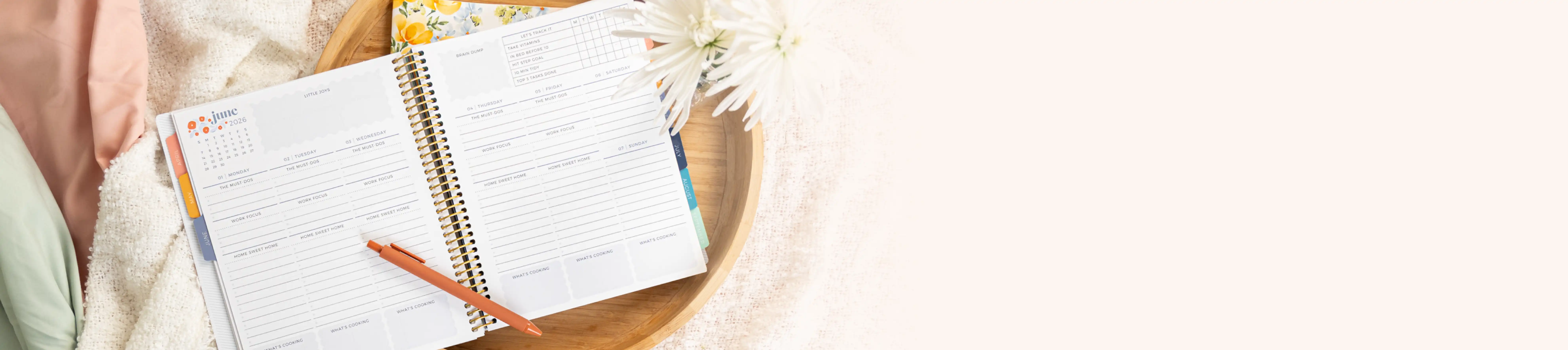 Bright Blooms weekly life planner open to the Bright Blooms Vertical layout with floral accents on a blanket Bright Blooms weekly life planner open to the Bright Blooms Vertical layout with floral accents on a blanket