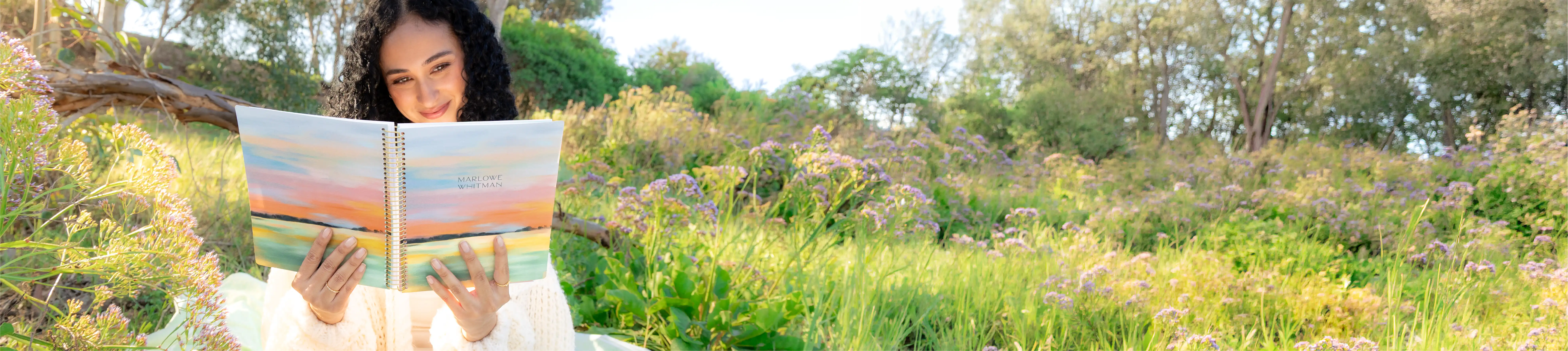 Two women on a couch with Plum Paper Planners