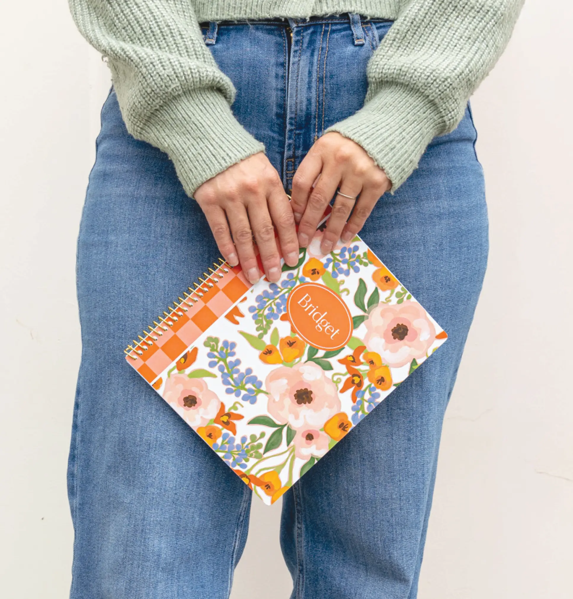 Woman carrying college student planner with customized cover. Woman carrying college student planner with customized cover.
