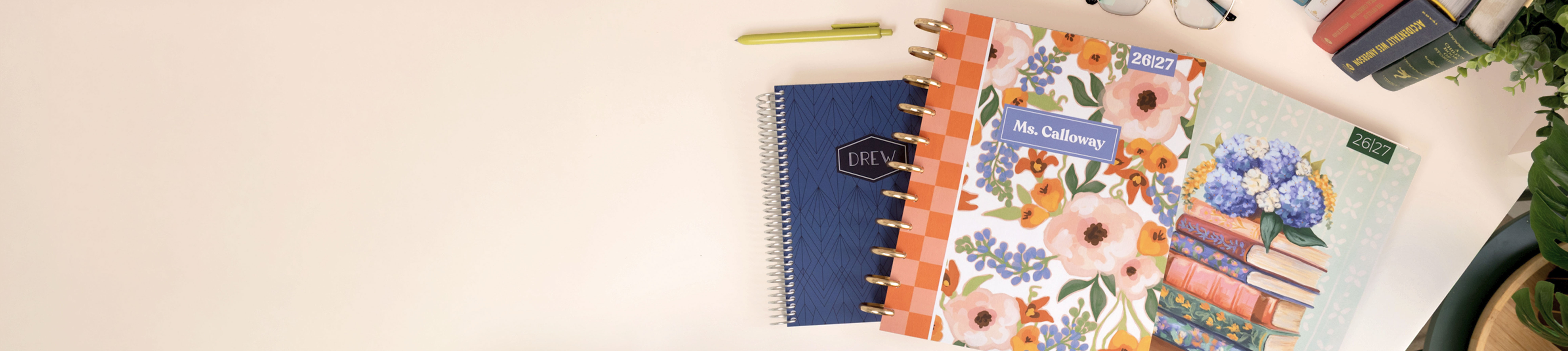 3 custom Plum Paper planners on a desk 3 custom Plum Paper planners on a desk