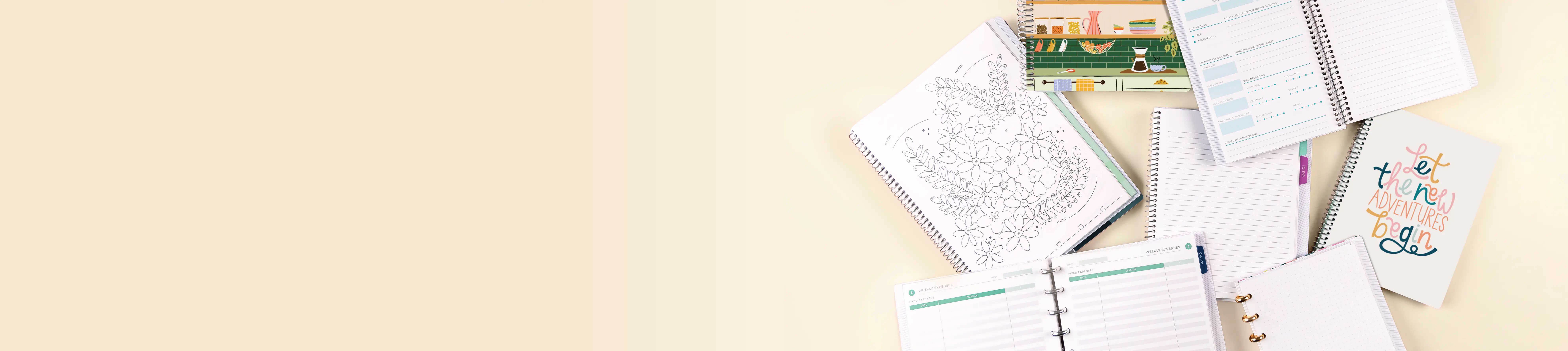 Notebooks laying flat showing different layouts with a beige background