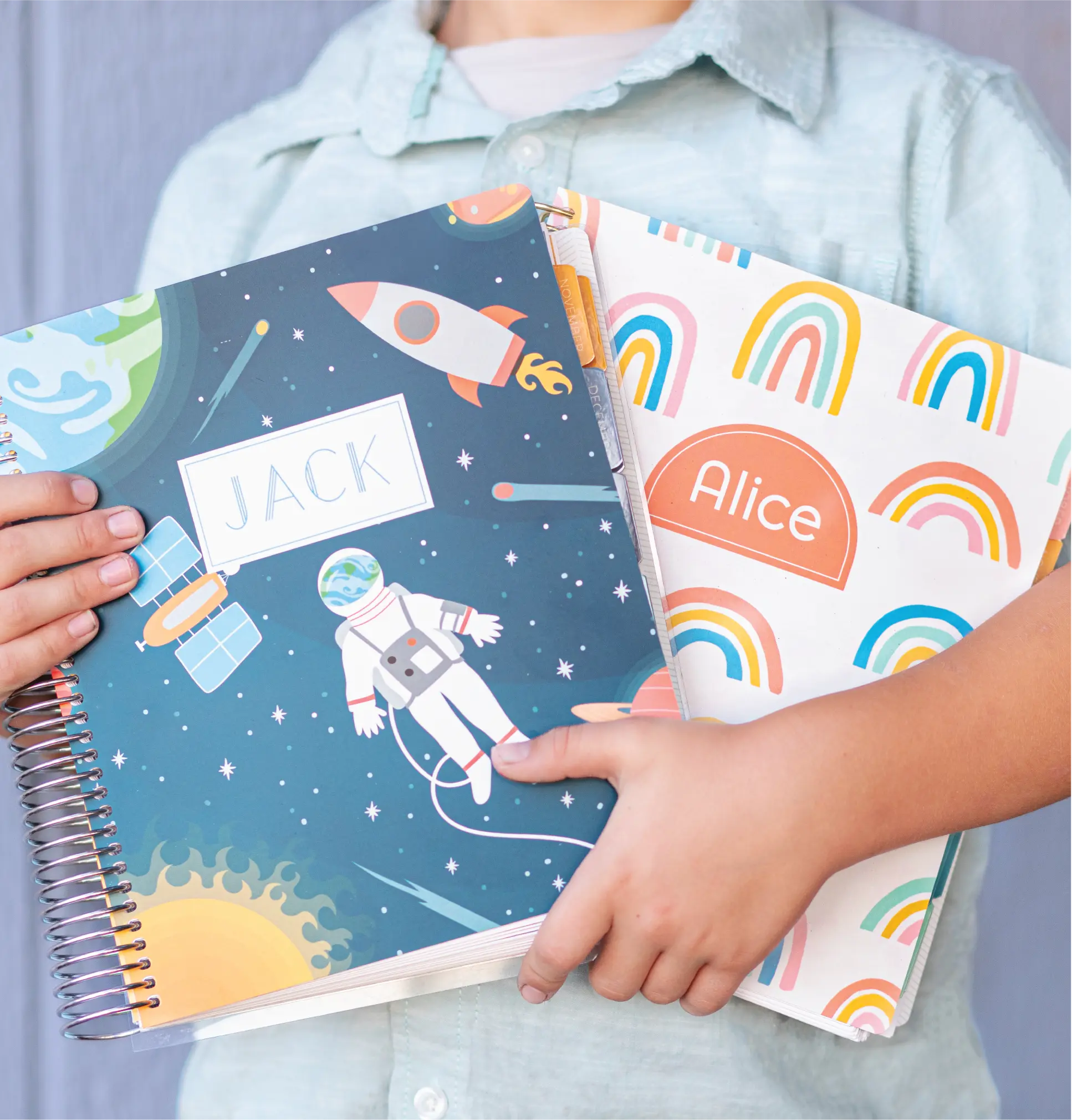 Woman holding planner and journal with customized covers. Woman holding planner and journal with customized covers.