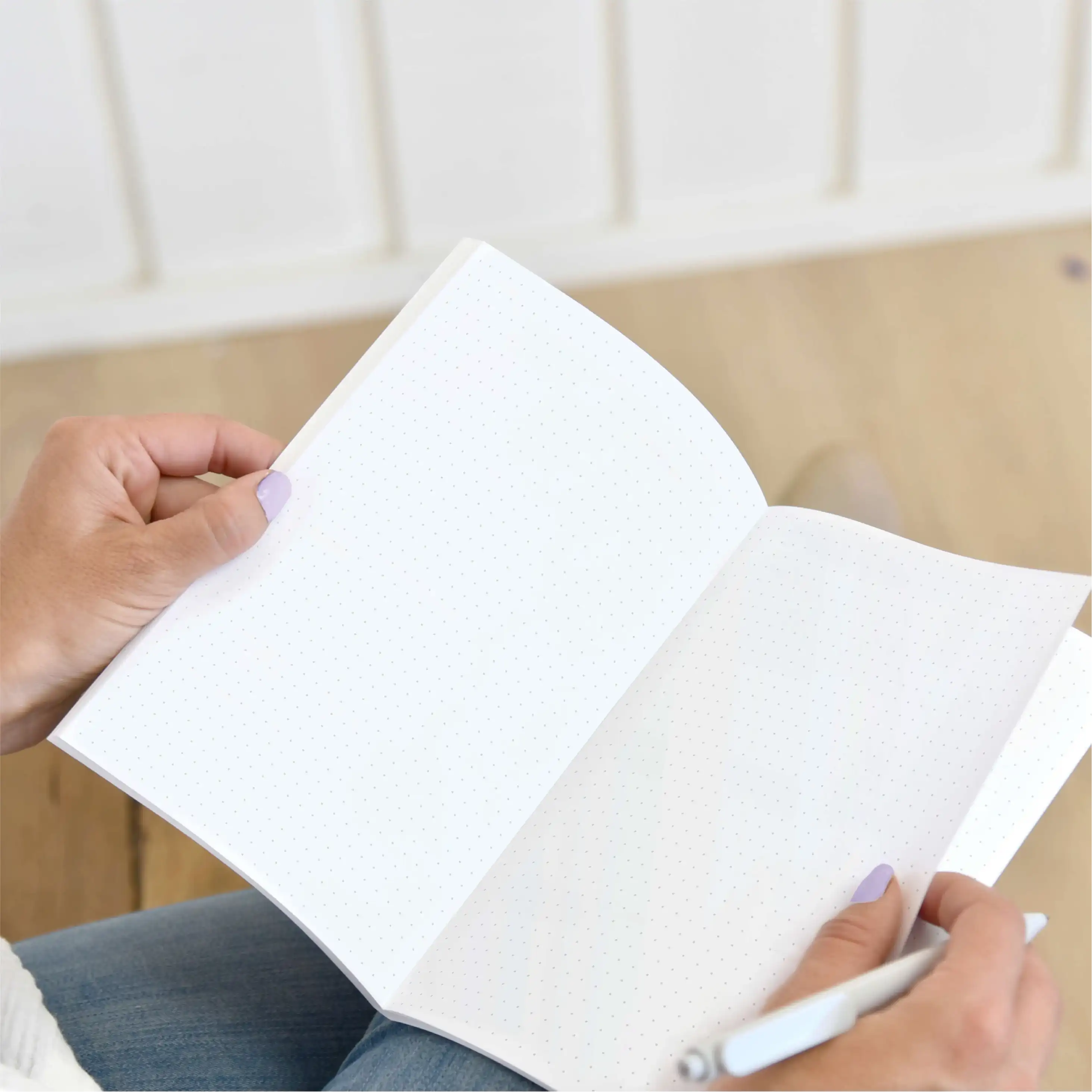 Woman holding a medium Saddle Stitched Planner with Dotted Notes Pages Woman holding a medium Saddle Stitched Planner with Dotted Notes Pages